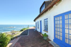 a house with blue doors and a view of the ocean at 61 Lutie Katz in Yzerfontein