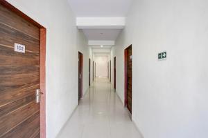 a corridor of a hospital with two doors at Townhouse Manipal University Highway King Bagru Formerly Golden Hotel in Jaipur