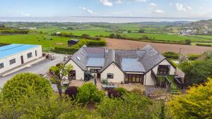 an aerial view of a house and a barn at Arosfa in Holywell