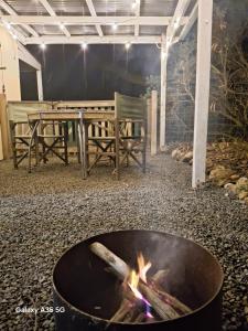 a fire pit with a table and a bench at Lazy Shanty in American River