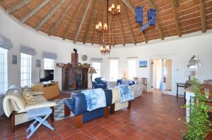 a living room with a couch and a tv at 61 Lutie Katz in Yzerfontein