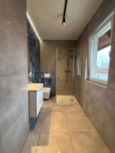 a bathroom with a shower and a sink at Apartamenty u Rybaka in Stężyca +24 photos