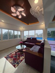 a living room with a couch and a table at Yercaud Rathna Residency in Yercaud