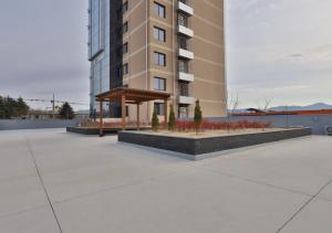 a large apartment building with a bench in front of it at 대구 빌리언웨스턴호텔 in Daegu