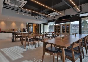 a dining room with wooden tables and chairs at 대구 빌리언웨스턴호텔 in Daegu