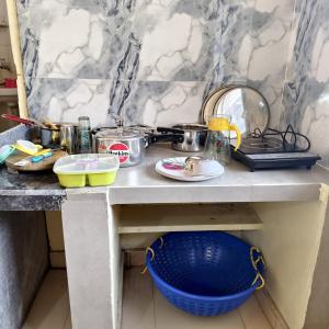a table with pots and pans and a bowl on it at Hotel B B Pride in Raipur +13 photos