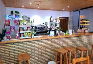 a bar with wooden stools in a restaurant at Hostal Restaurante Monterde de Albarracín in Monterde de Albarracín +11 photos