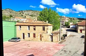 a small car parked in front of a building at Hostal Restaurante Monterde de Albarracín in Monterde de Albarracín