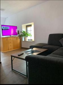 a living room with a couch and a coffee table at Vina am Ring Apartment in Mannebach