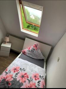 a small bedroom with a bed and a window at Vina am Ring Apartment in Mannebach