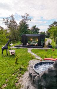 a house with a giraffe statue in a yard at Forest Chalet in Porumbacu de Sus