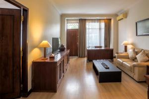 a living room with a couch and a table at Mesra International Hotel in Samarinda