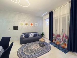 a living room with a couch and a table at Stefy's House in Scalea