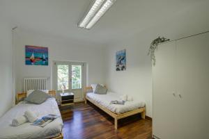 a room with two beds and a window at Maroggia Apartments in Maroggia