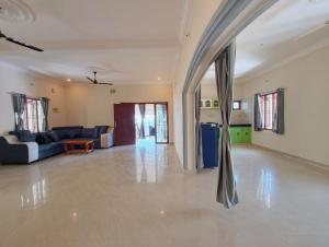 an empty living room with a couch and a table at Eesha Elite - Rameswaram in Rāmeswaram