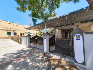 a house with a fence and a gate at Eesha Elite - Rameswaram in Rāmeswaram