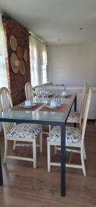 a dining room with a table and chairs with wine glasses at Moraes Residence in Belo Horizonte