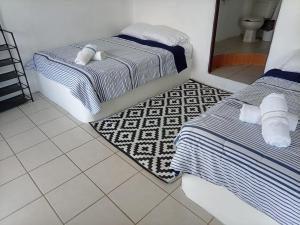 a bedroom with two beds and a mirror in it at Pacha beach club in Barra de Tuxpan