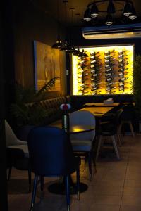 a dining room with a table and chairs and a wine cellar at Guest House LeGourmet in Kata Beach