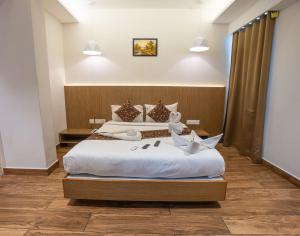 a hotel room with a bed with a paper boat on it at GRAND ONE TOWER in Chennai