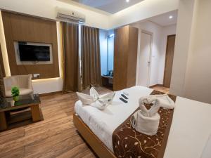a hotel room with a bed and a chair at GRAND ONE TOWER in Chennai