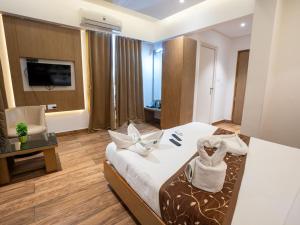 a hotel room with a bed and a chair at GRAND ONE TOWER in Chennai
