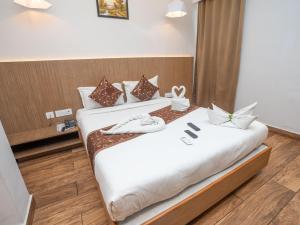 two beds in a hotel room with towels on them at GRAND ONE TOWER in Chennai +32 photos