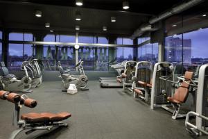 a gym with cardio equipment in a building at Hyatt Regency Hesperia Madrid in Madrid