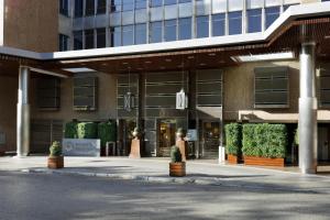 a large building with plants in front of it at Hyatt Regency Hesperia Madrid in Madrid