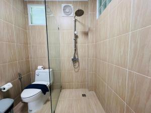 a bathroom with a shower with a toilet and a glass shower at Villa H in Surin Beach