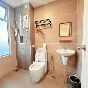 a bathroom with a toilet and a sink at KULAI IOI MALL D'Putra Suites Near JPO Senai Airport in Kampong Saleng +94 photos
