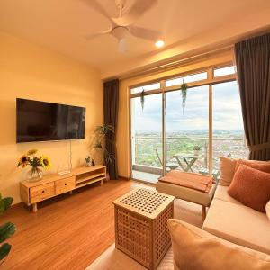 a living room with a couch and a large window at KULAI IOI MALL D'Putra Suites Near JPO Senai Airport in Kampong Saleng