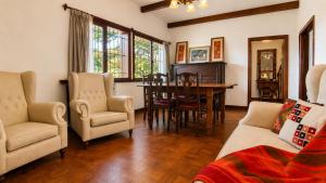 a living room with a table and chairs and a dining room at Centrally located lakefront house in San Carlos de Bariloche