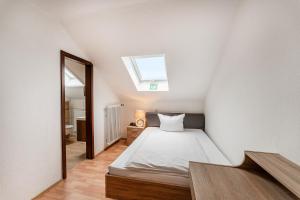 a bedroom with a bed and a skylight at Hotel Glas Schwarzwald in Fluorn