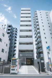 two tall white buildings next to each other at b&黒門3号店 in Osaka
