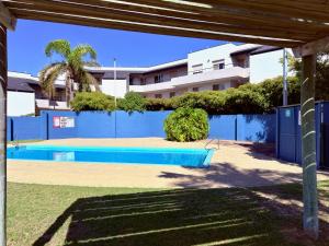 a swimming pool in front of a building at Sound Views Apartment in Safety Bay