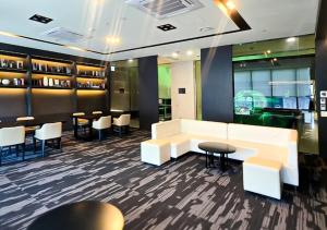 a restaurant with white furniture and tables and chairs at Kinstay Hotel in Goyang