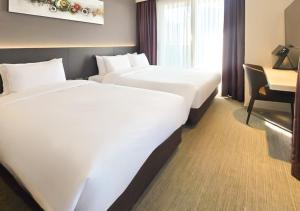 a hotel room with two beds and a desk at Kinstay Hotel in Goyang
