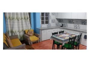 a kitchen and dining room with a table and chairs at Kadamba Bnb Homestay in Kurseong