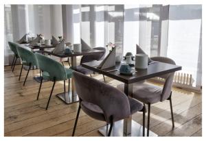 a row of tables and chairs with laptops on them at Waldhotel Wandlitz in Wandlitz