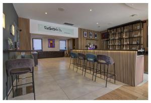 a bar in a store with bar stools at Waldhotel Wandlitz in Wandlitz +64 photos
