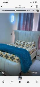 a bedroom with a blue bed with a blue blanket at Kiminini bnb in Kitale