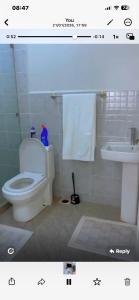 a bathroom with a white toilet and a sink at Kiminini bnb in Kitale