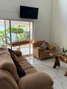 a living room with a couch and a table at Cocos House Zicatela in Puerto Escondido