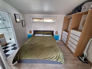 a bedroom with a large bed in a room at Beach Pad in Whangamata