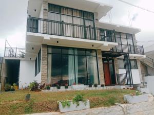 a house with balconies on the side of it at Falcon View in Nuwara Eliya