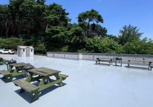 a group of picnic tables sitting on a patio at HwiMokArt Resort in Buan