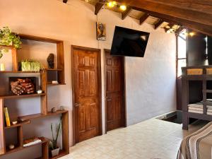 a room with a door and a tv on the wall at Cabañas M&S By GEstores in Huasca de Ocampo