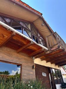 a wooden house with a balcony and a door at Cabañas M&S By GEstores in Huasca de Ocampo