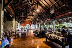 a restaurant with tables and chairs in a room at Mesra International Hotel in Samarinda